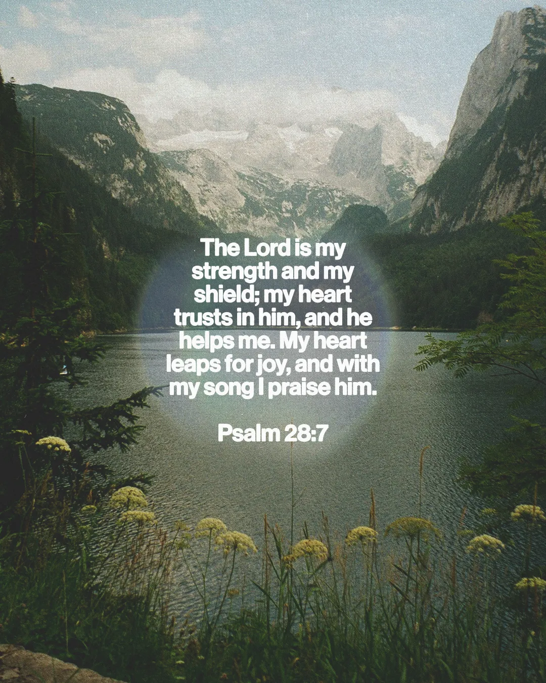 Psalm 28:7 text over a serene lake and mountains, symbolizing faith, strength, and joy in worship.