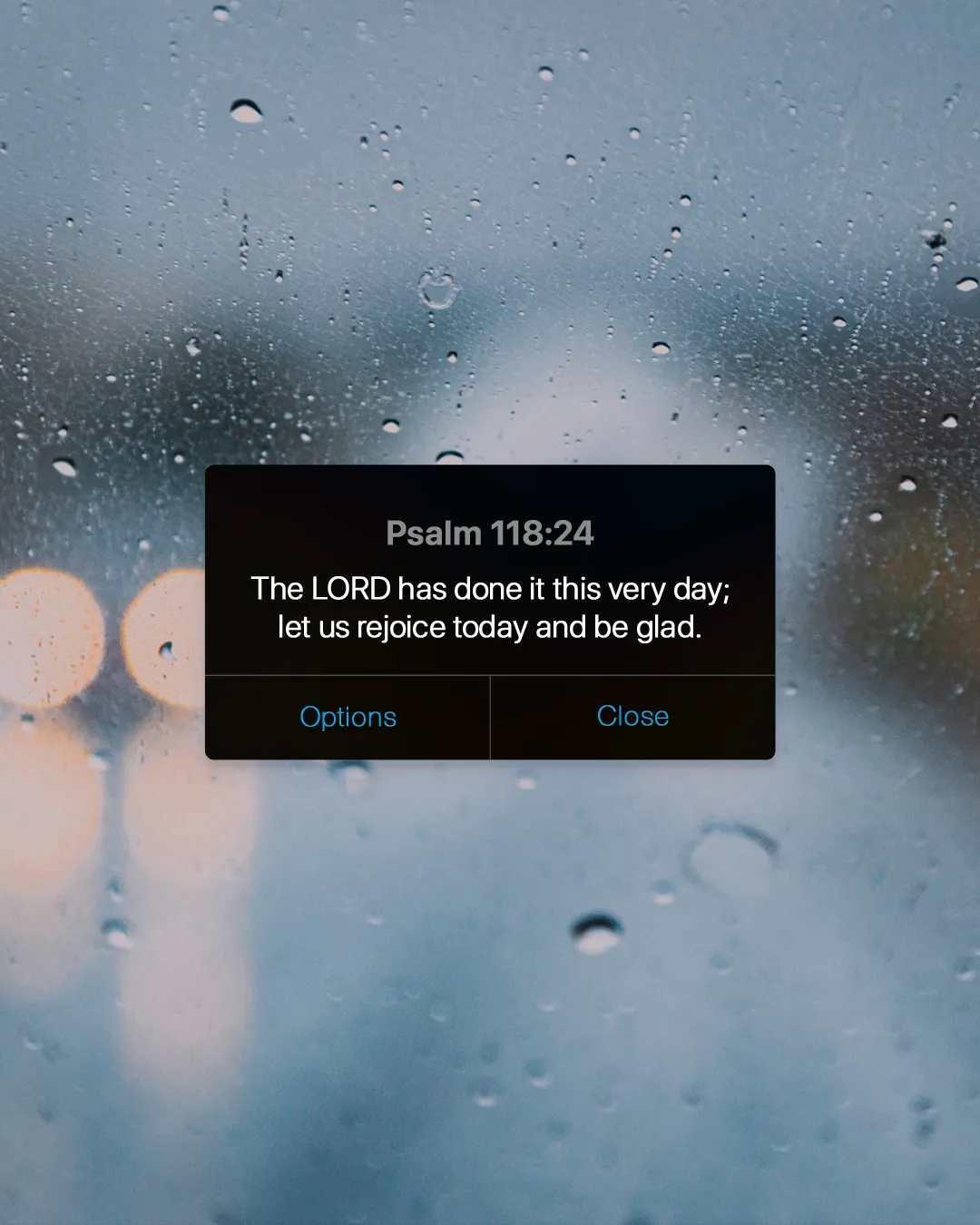 Raindrops on glass with a text overlay of Psalm 118:24, expressing joy and gratitude in faith.