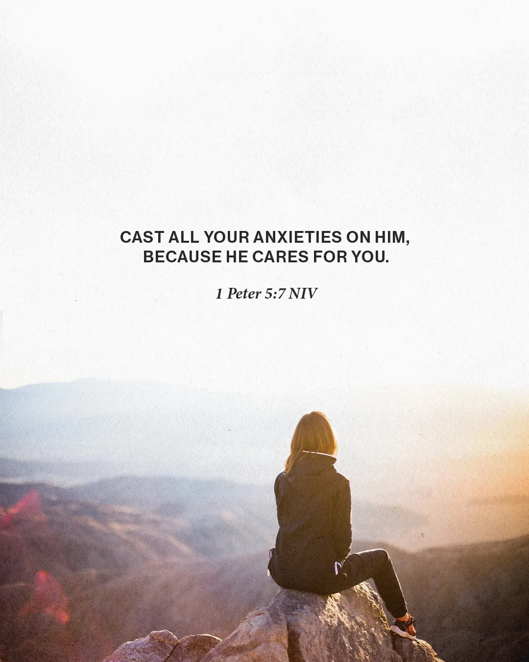 Person sitting on mountain at sunrise reflects on 1 Peter 5:7, trusting God's care and releasing anxieties.