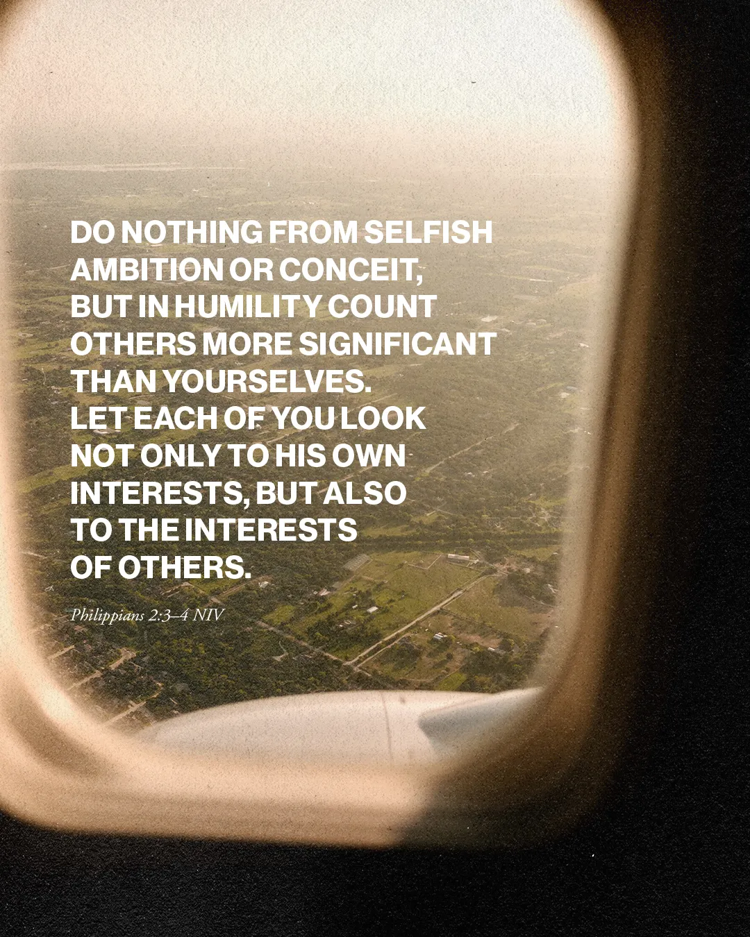 Bible verse from Philippians 2:3-4 on humility and putting others first, viewed through an airplane window.
