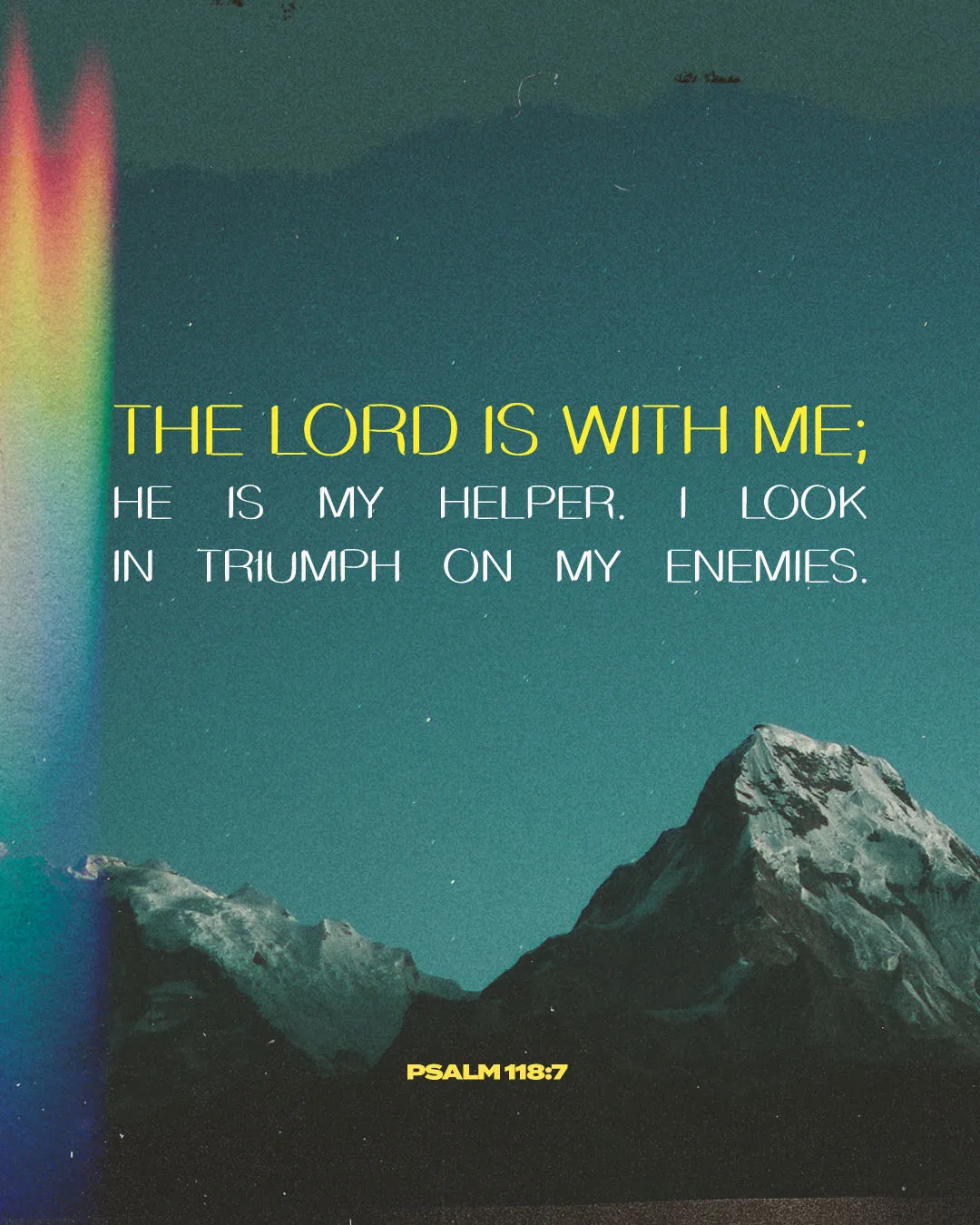 Modern church media featuring Psalm 118:7 "The Lord is with me; He is my helper. I look in triumph on my enemies" with yellow and white typography over a dramatic teal-toned mountain landscape.