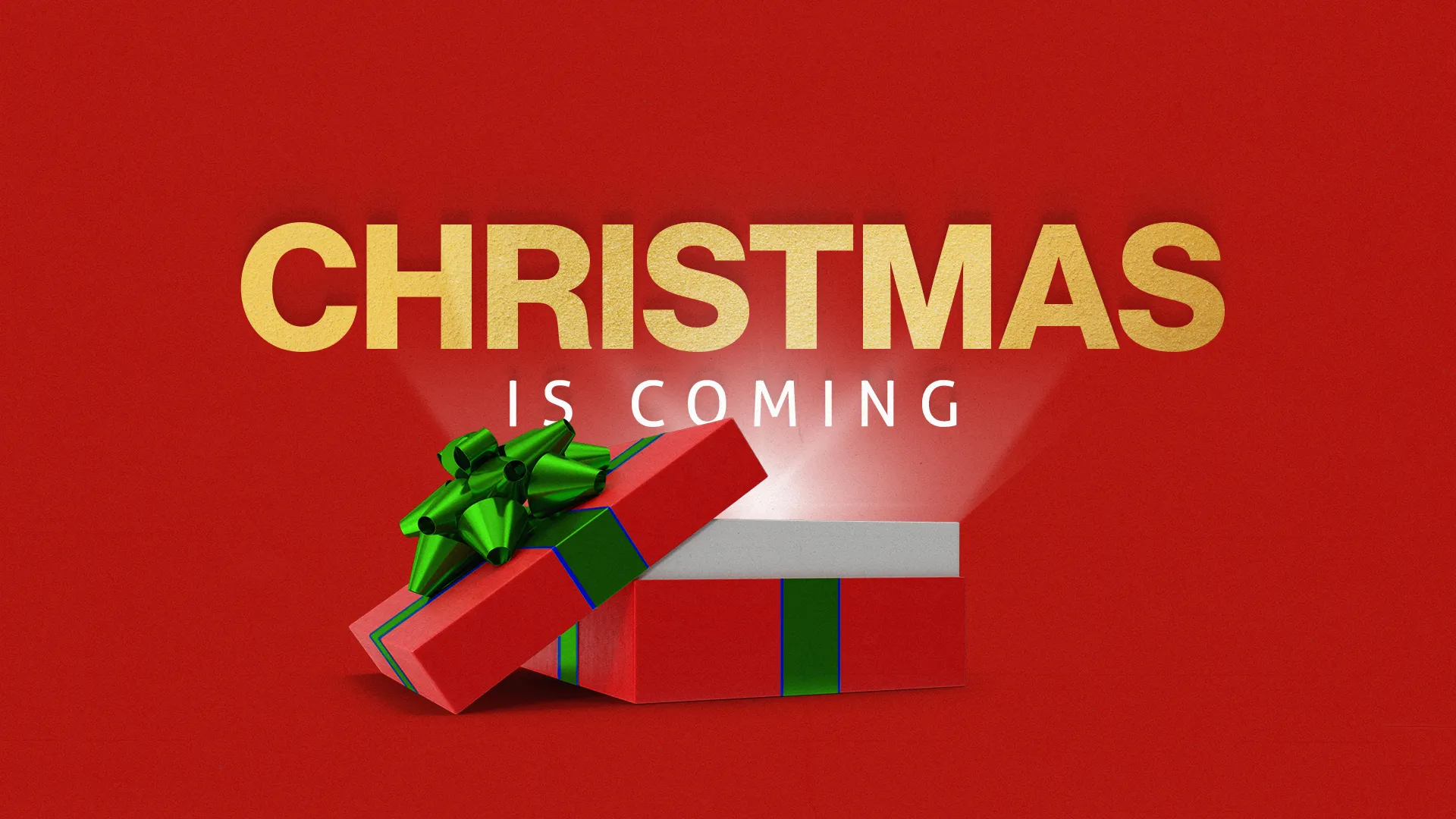 Christmas is coming text in gold with open gift box on red background