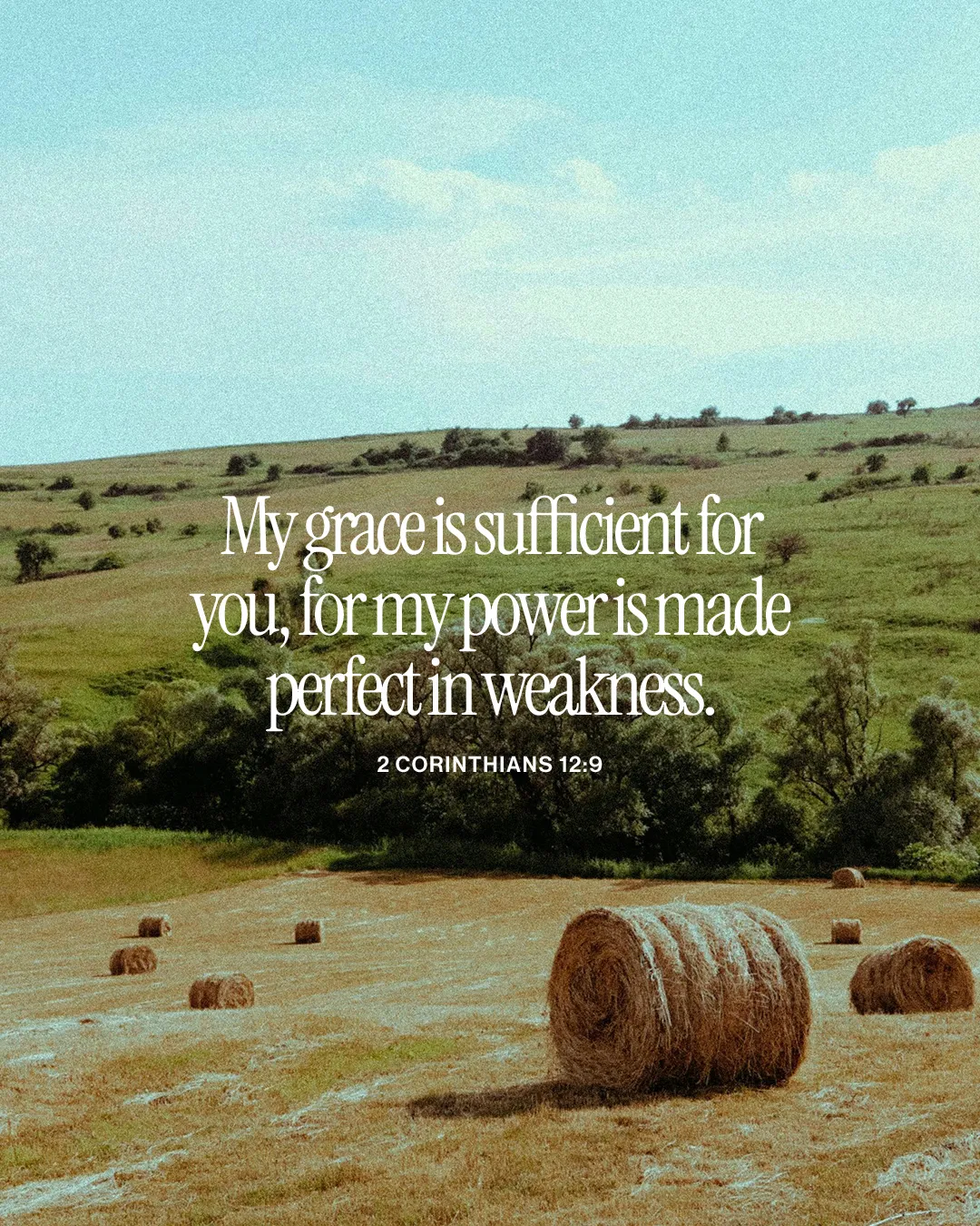 Serene countryside with hay bales and a biblical quote on grace and strength from 2 Corinthians 12:9.